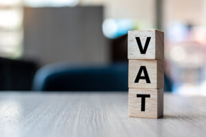 wooden cube with VAT text on table background. Financial, marketing and business concepts